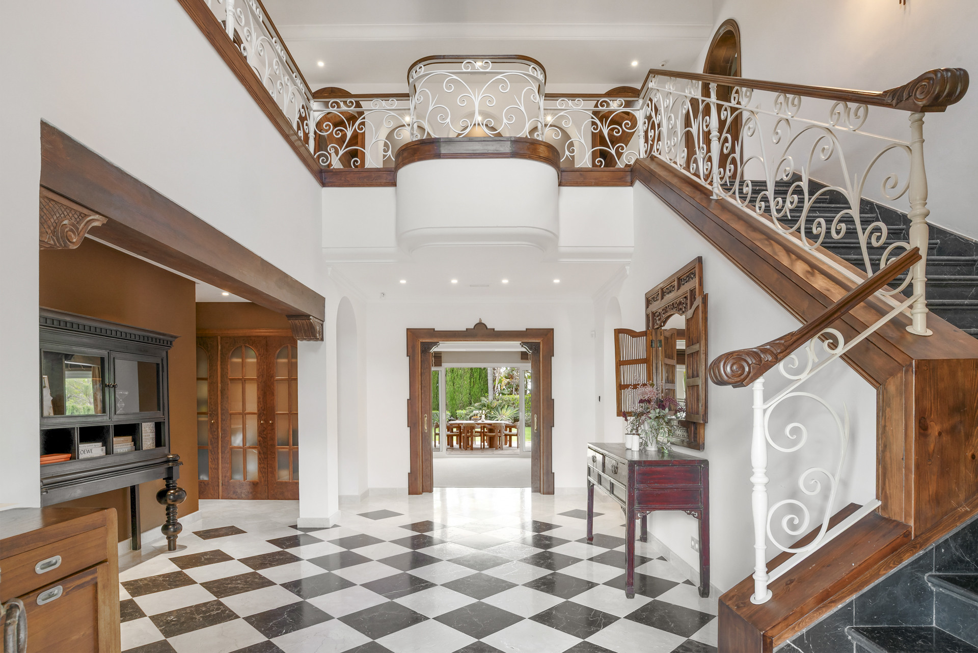 Staircase view from lower level with decorative railing.