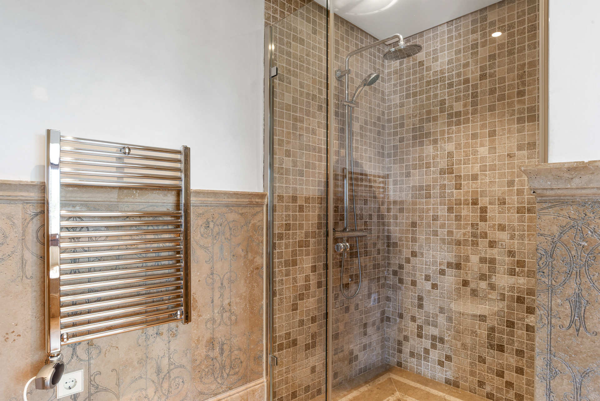 Modern shower area with a glass enclosure and tiled walls for a clean look.