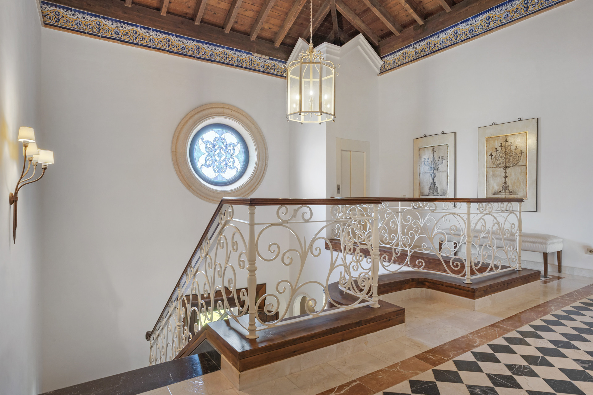 Landing area featuring circular window and decorative ceiling.