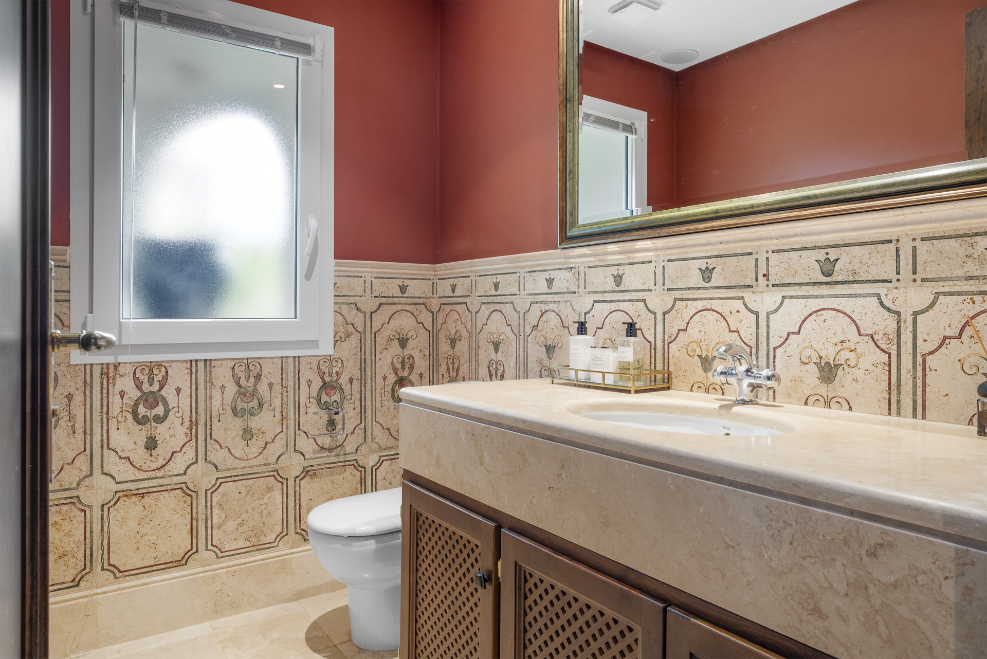 Modern bathroom with decorative wall tiles and window.