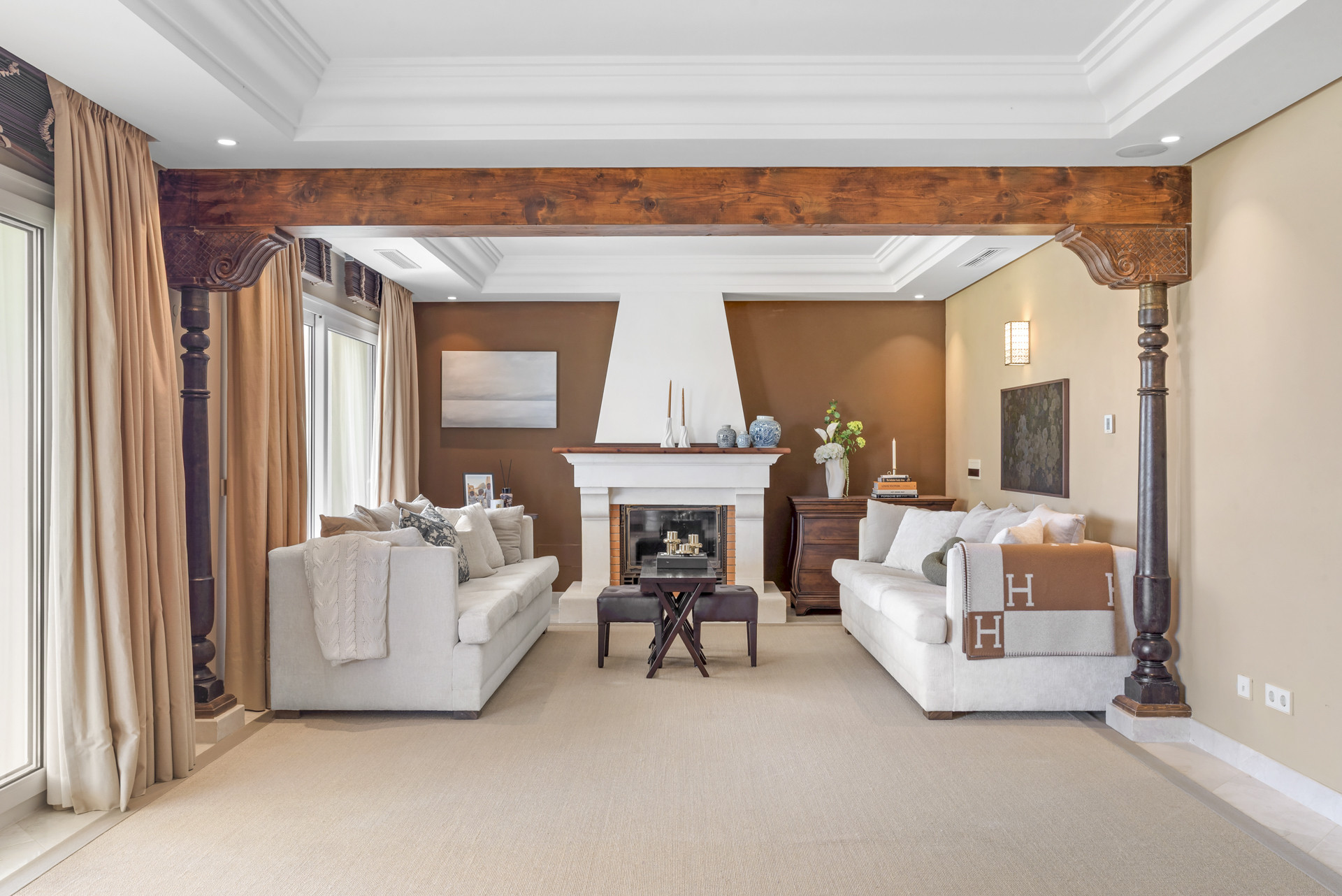 Spacious living room with two sofas, a fireplace, and decorative furniture.