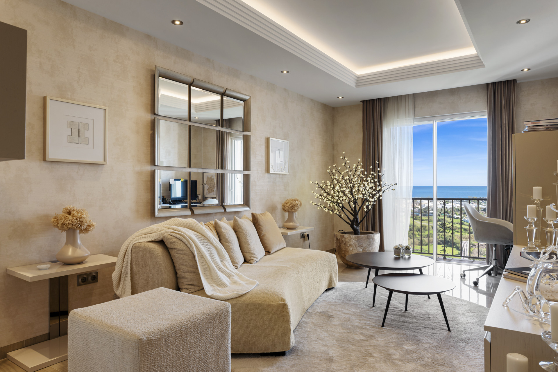 Living room with textured walls, beige sofa, round coffee tables, and balcony view.