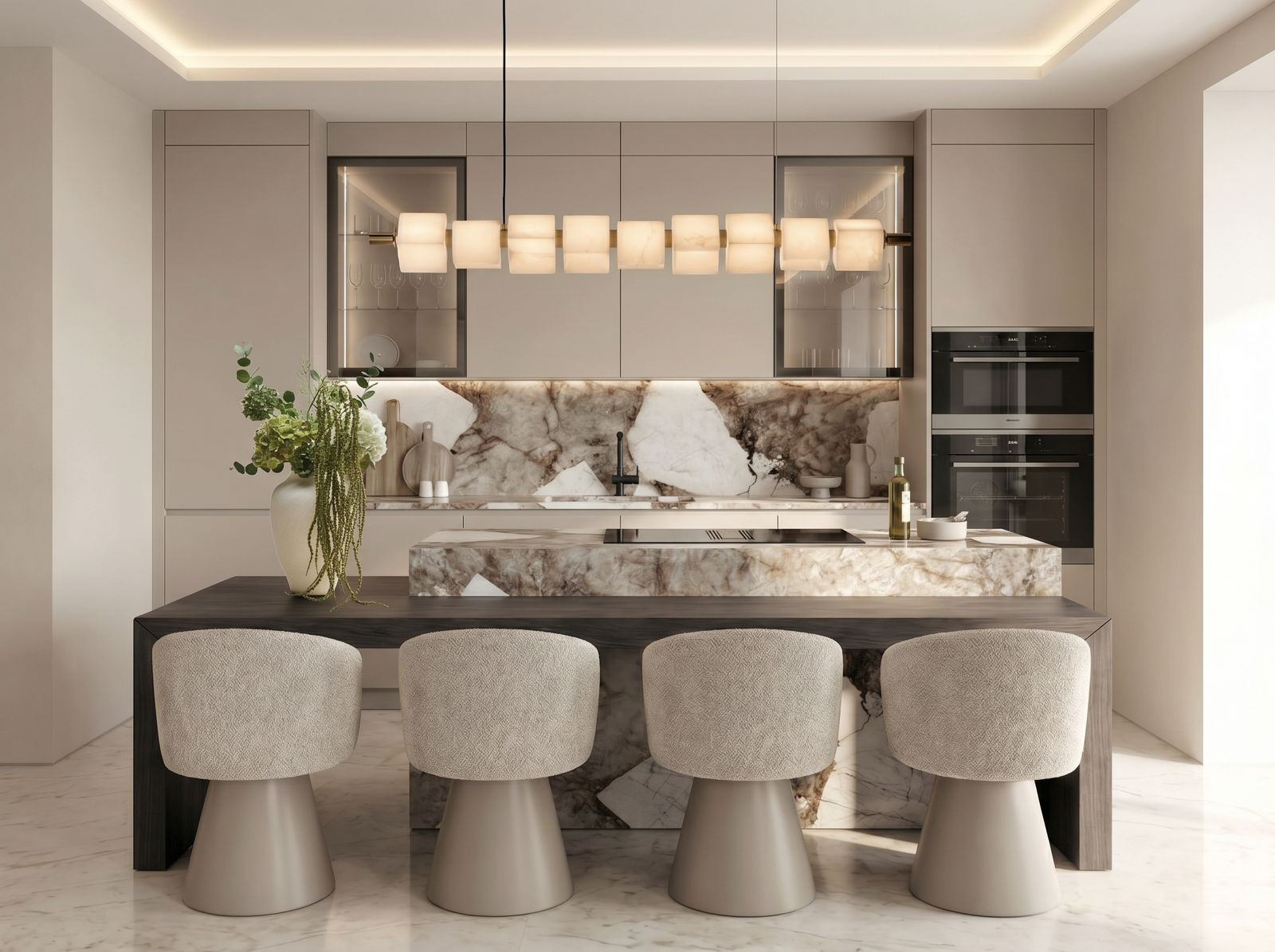 Modern kitchen with a long island, seating for four, marble backsplash, integrated appliances, and linear chandelier.