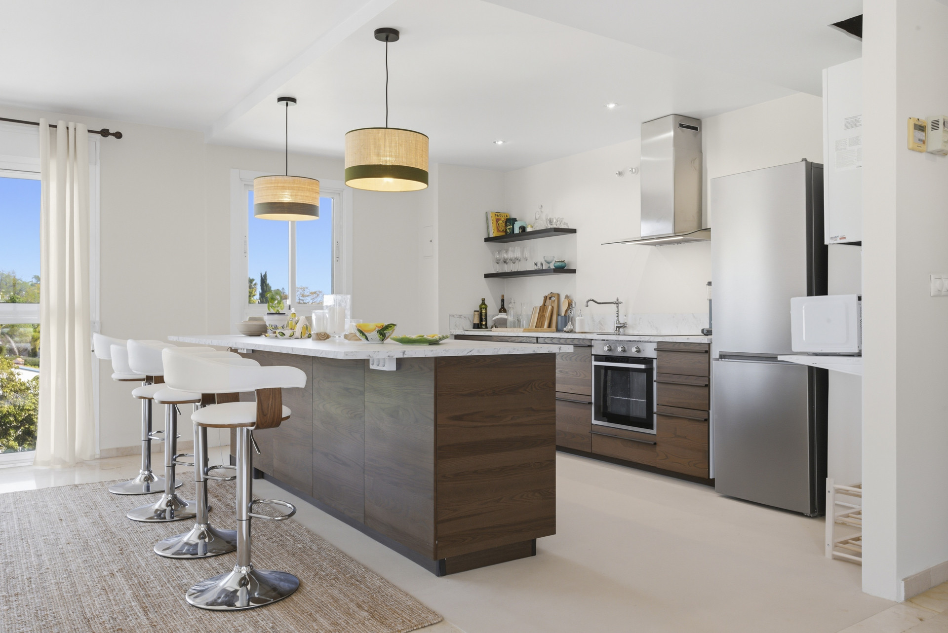 Detailed view of the kitchen island with a marble countertop and open shelves.