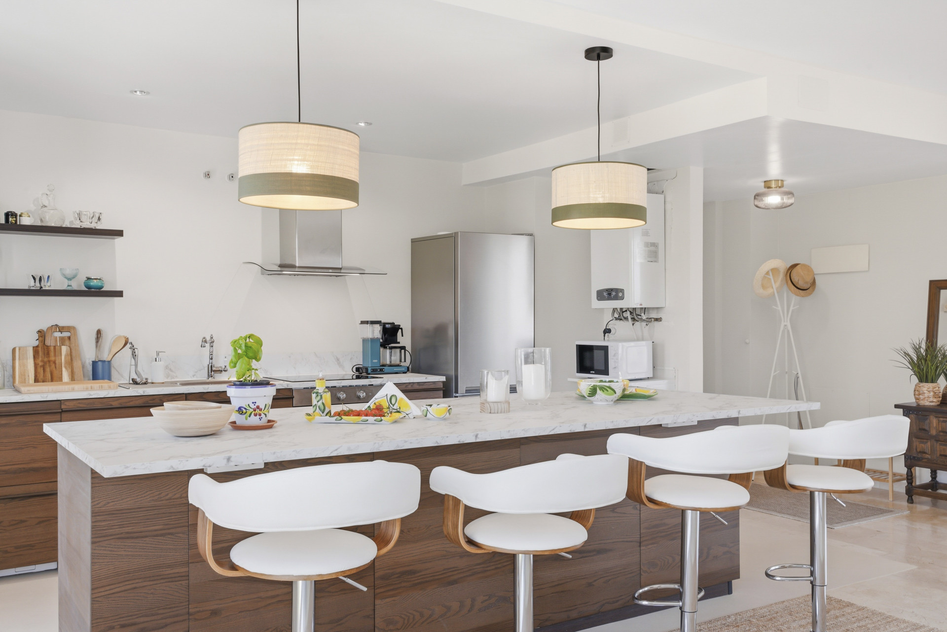Close-up focus on kitchen design elements including bar stools and decorative items.