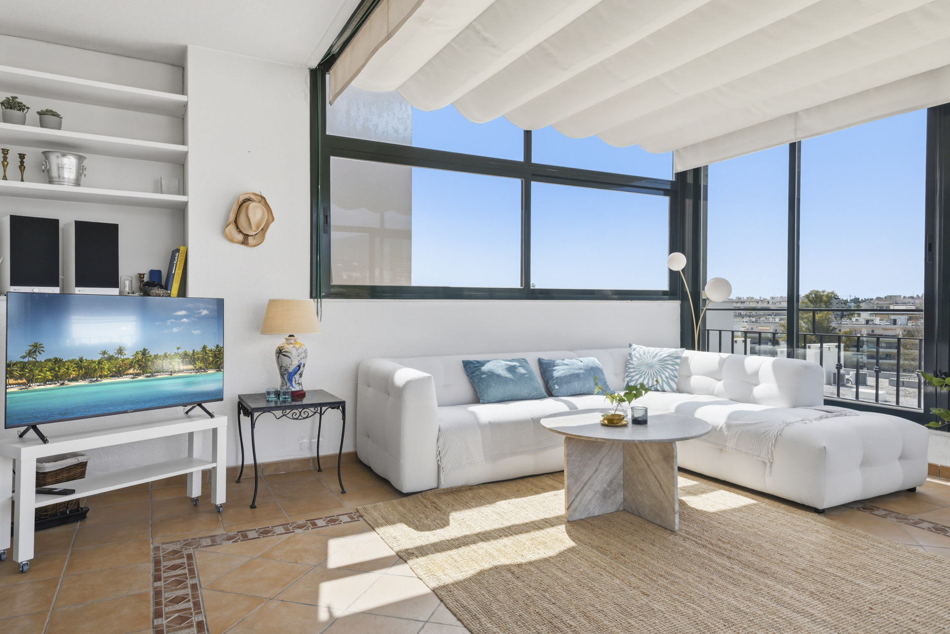 Bright living area with white sofa and large windows.
