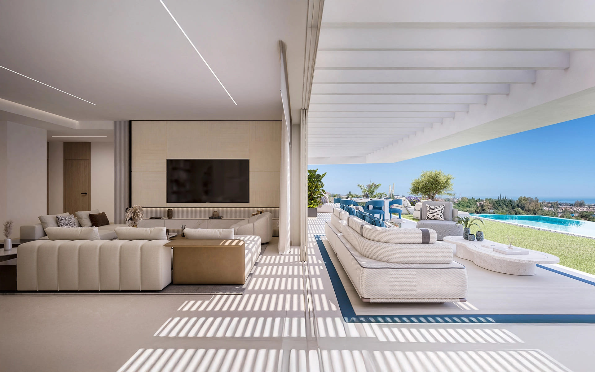 Indoor living room and outdoor lounge area, with a pool and sea view beyond.