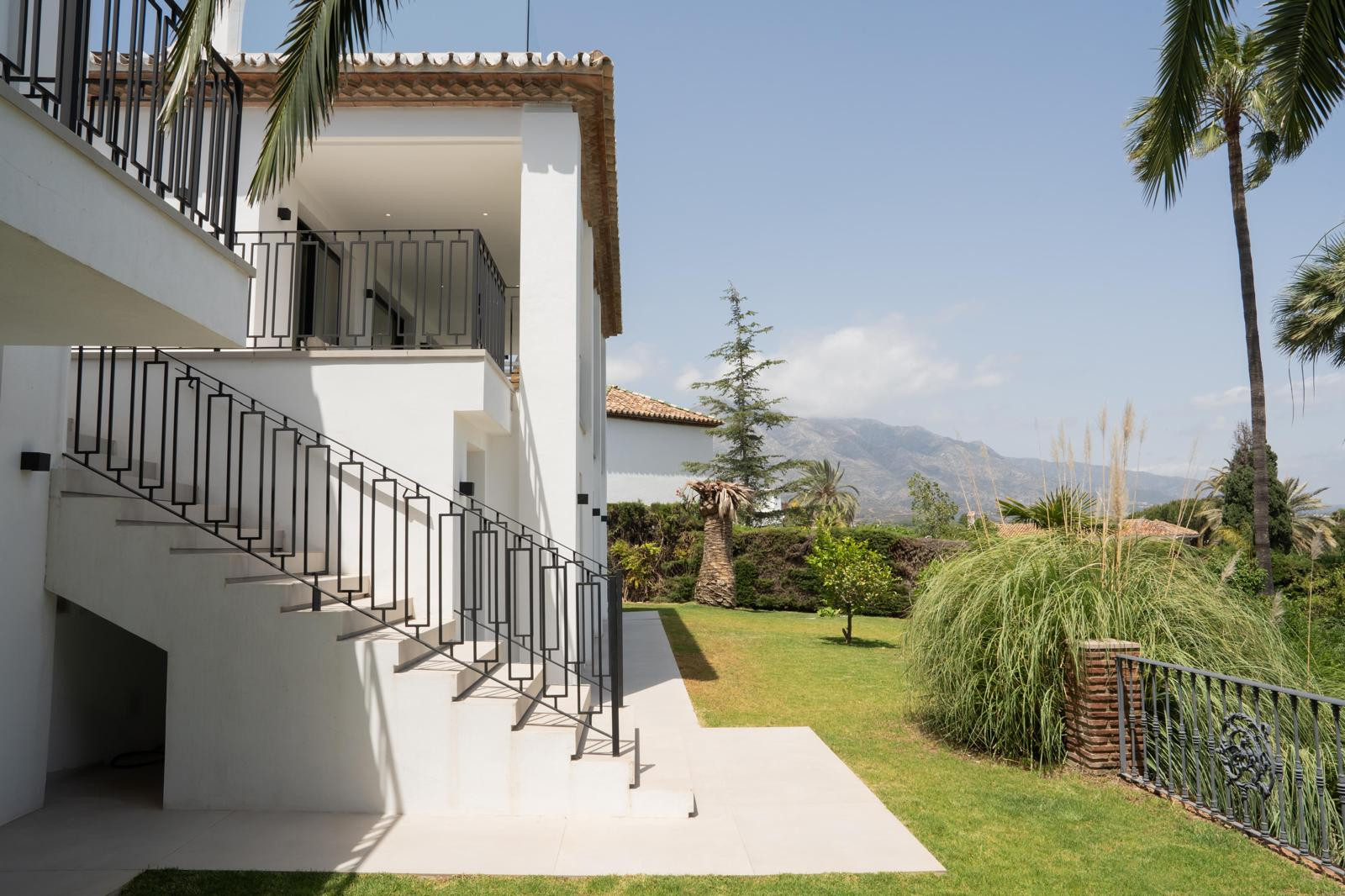 Side view featuring stairs leading to upper levels.