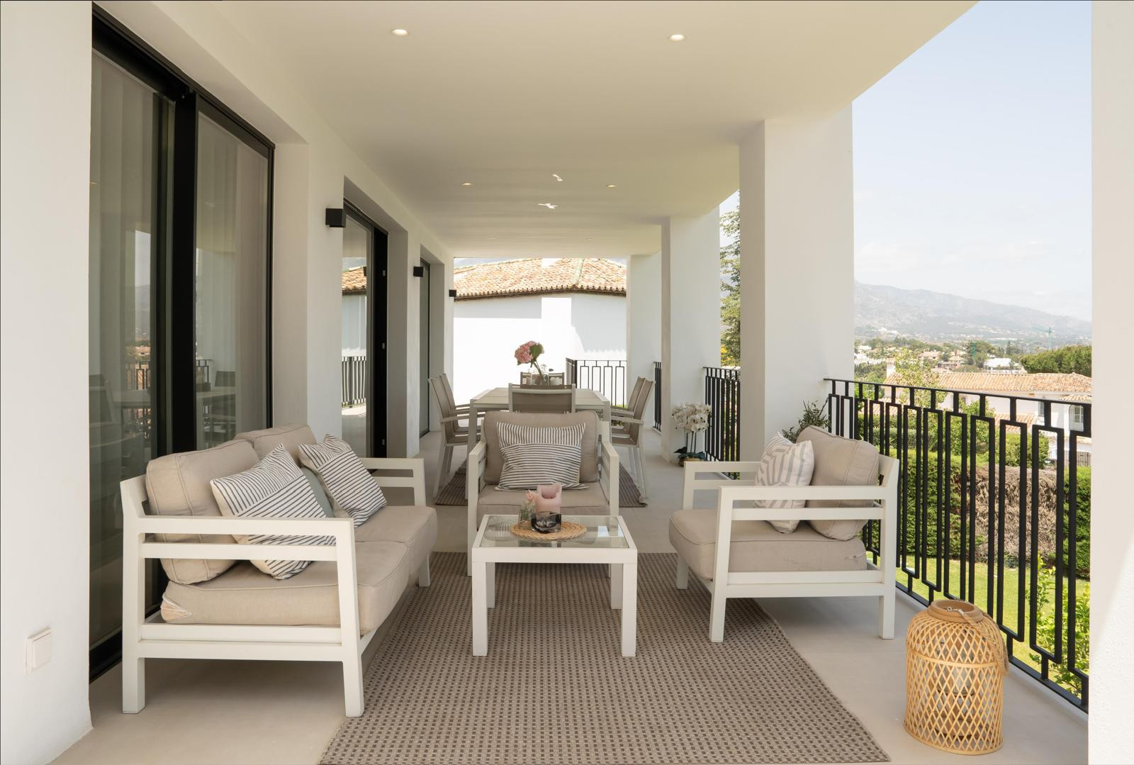 Spacious terrace featuring comfortable seating and a dining area with mountain views.
