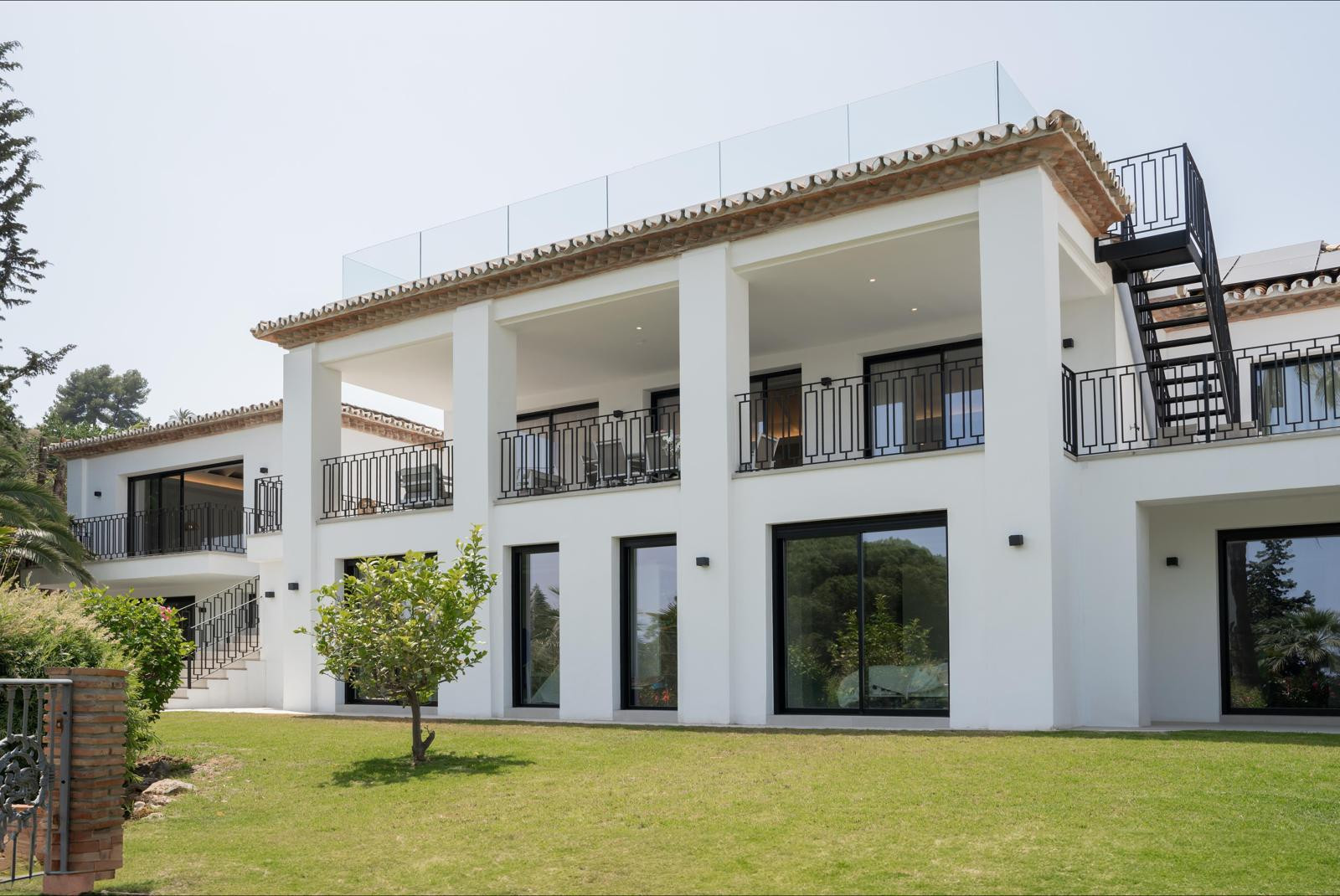 Exterior view of the villa showcasing large windows and balconies.