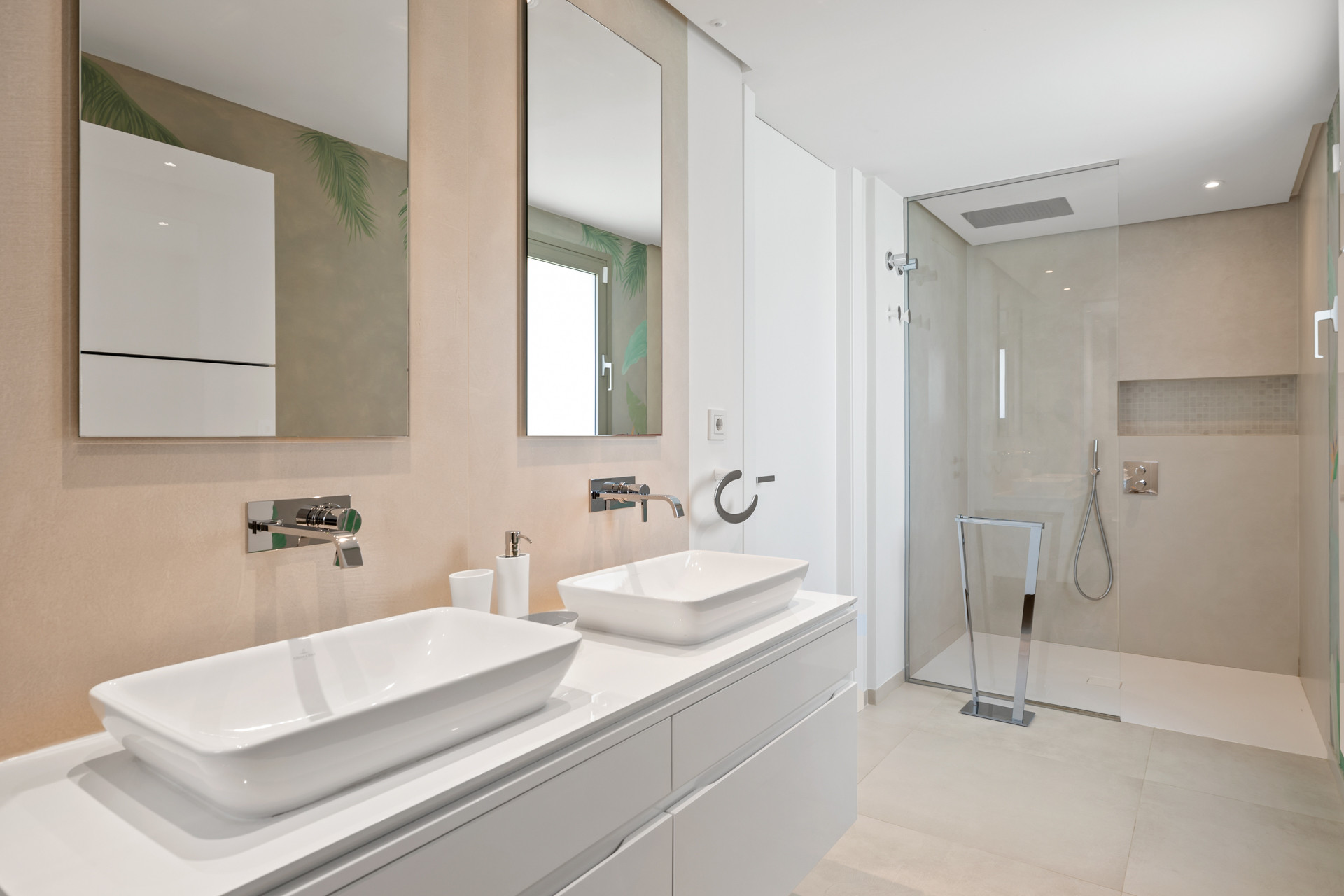 Bathroom with a dual vanity, two rectangular sinks, and a large, open glass shower on the right.