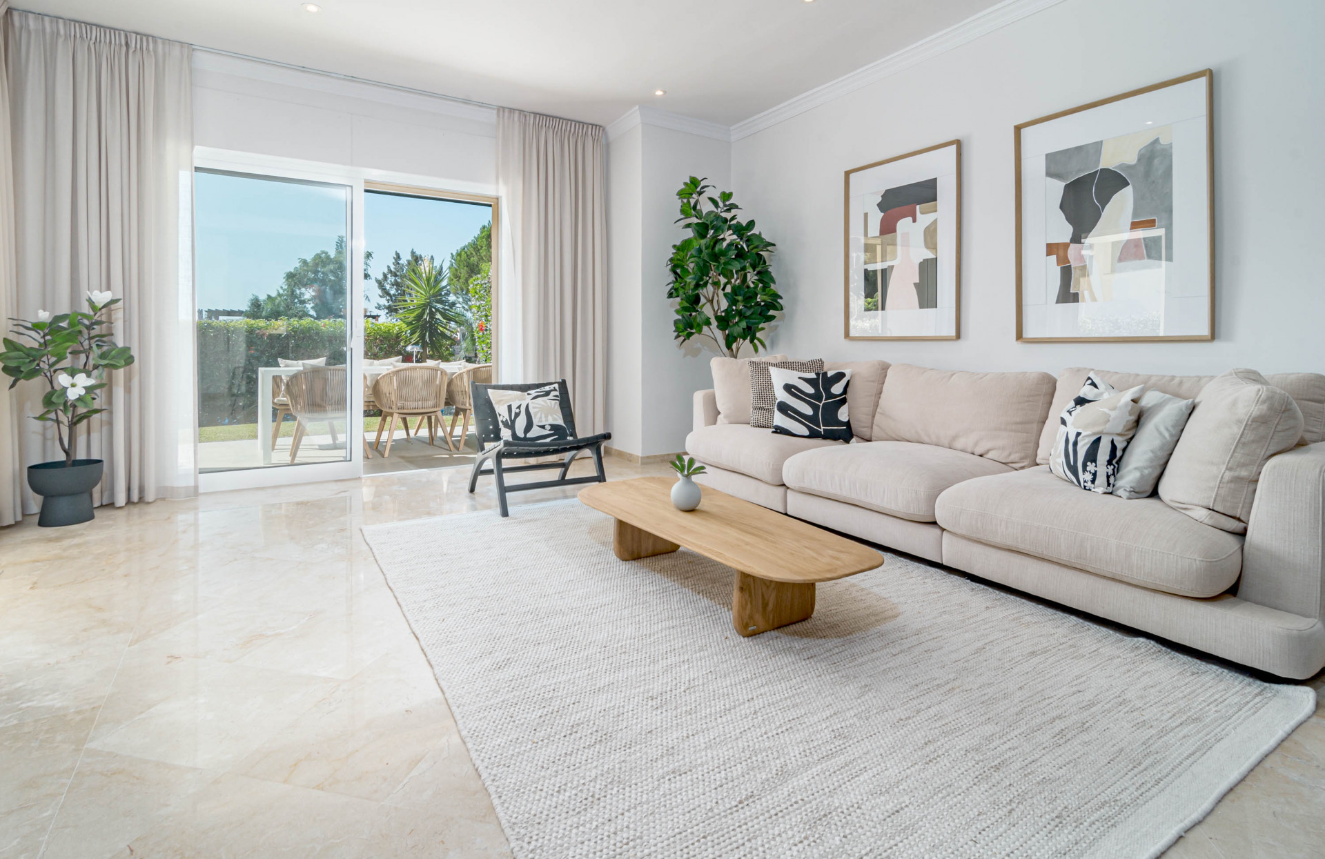 Bright living room with large beige sofa, wood coffee table, and sliding doors to an outdoor patio.