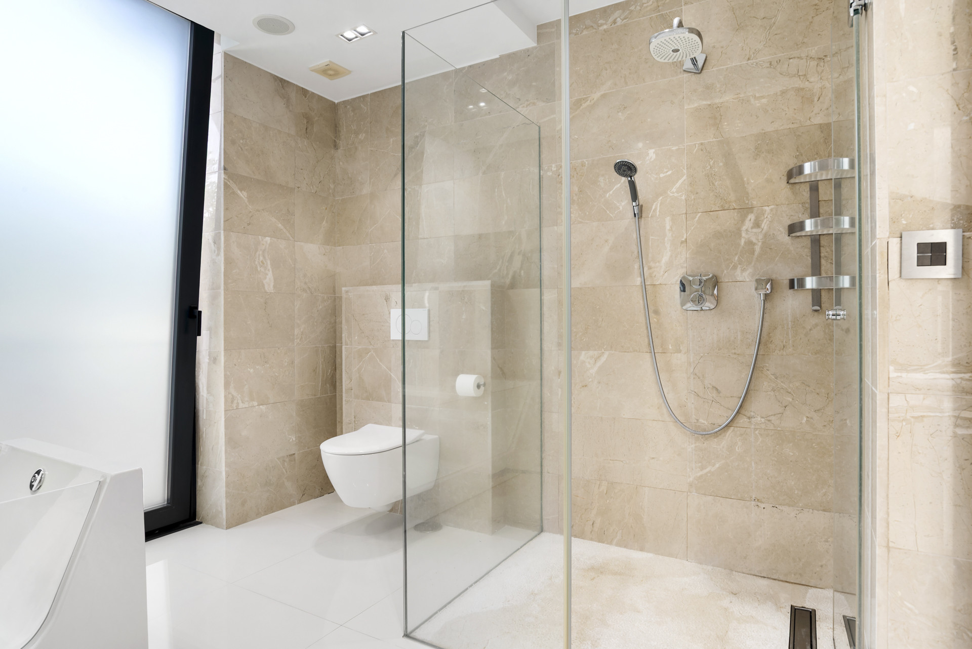 Contemporary bathroom showcasing a walk-in shower, chic fixtures, and minimalist design.