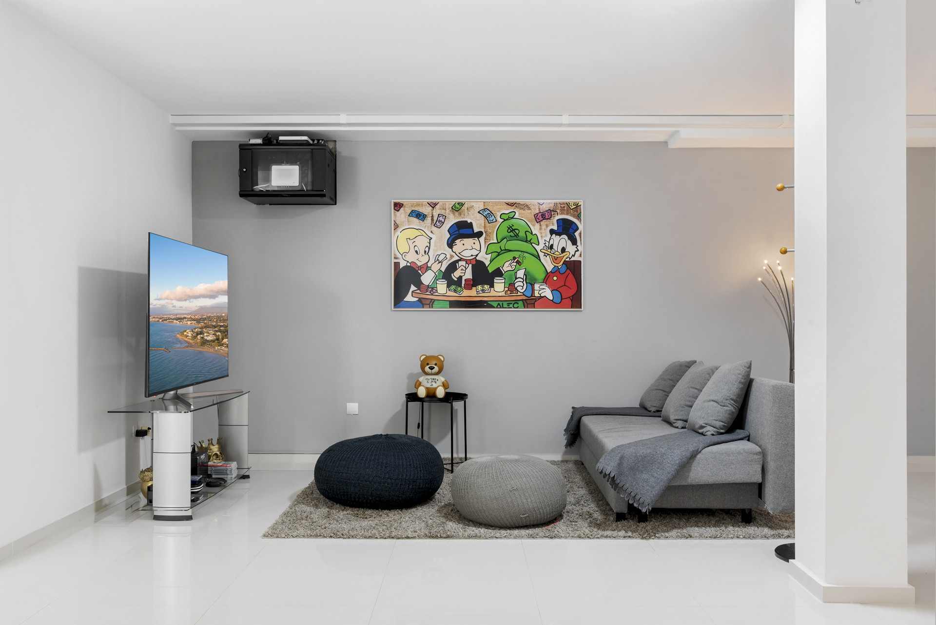 Cozy lounge area with a TV and colorful artwork.