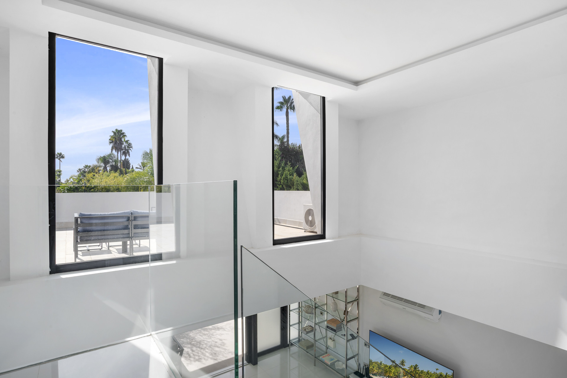 View of partial living area with large windows and terrace access in Marbella house.