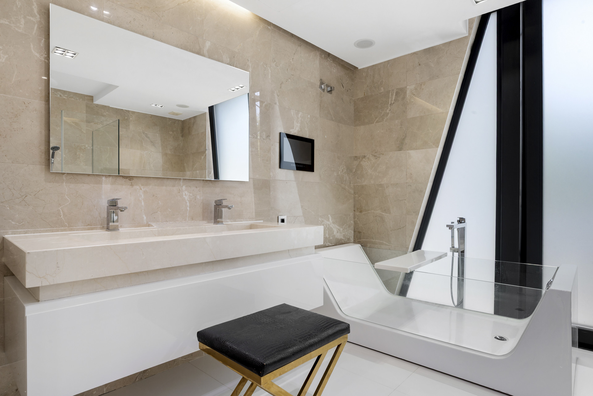 Modern bathroom with dual sinks, large mirror, and stylish bathtub.