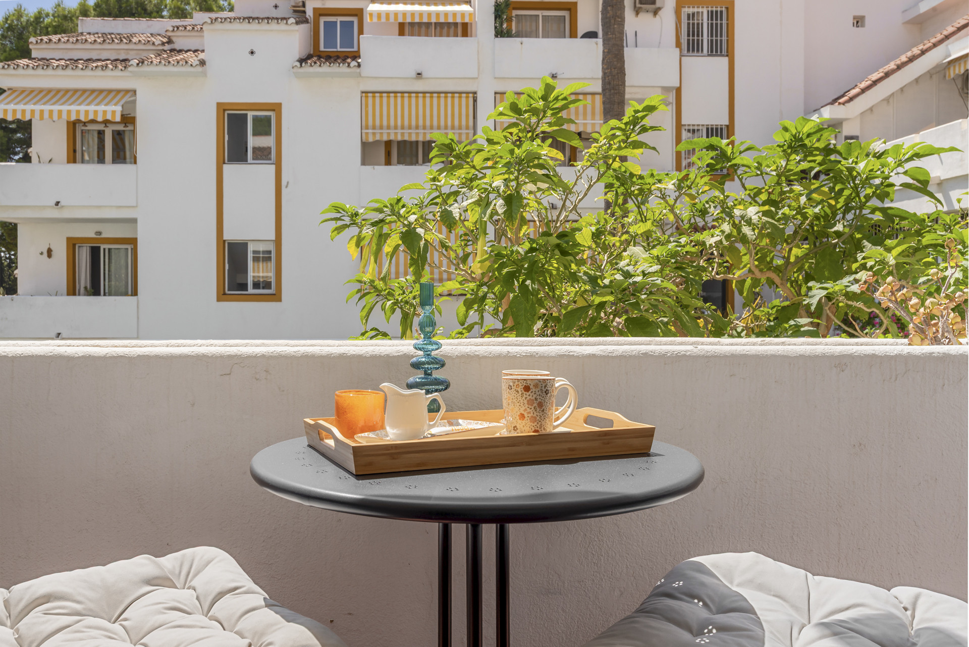 Table with drinks on a balcony overlooking the apartment complex.