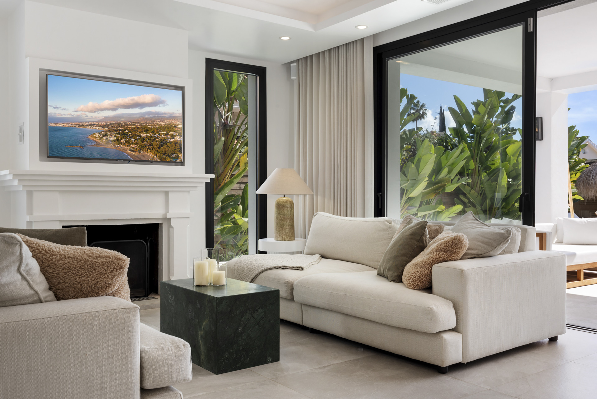 Stylish lounge with a fireplace and TV overlooking the outdoor space