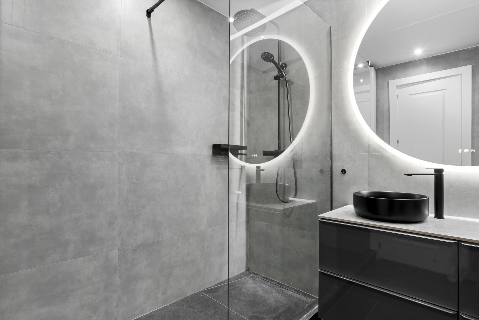 Shower area with glass enclosure and stylish faucet.