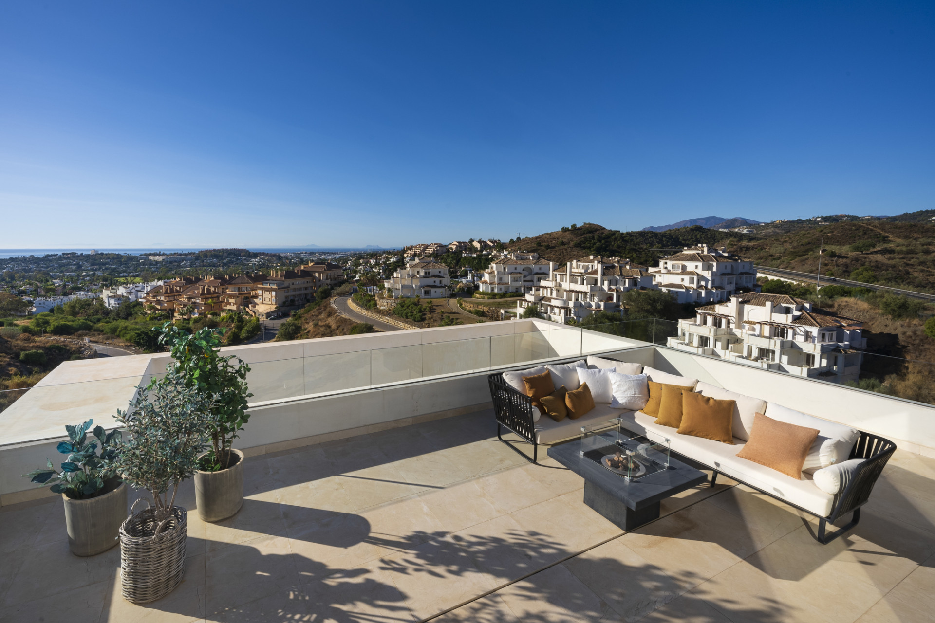 Large terrace with seating area and view of surrounding landscape.