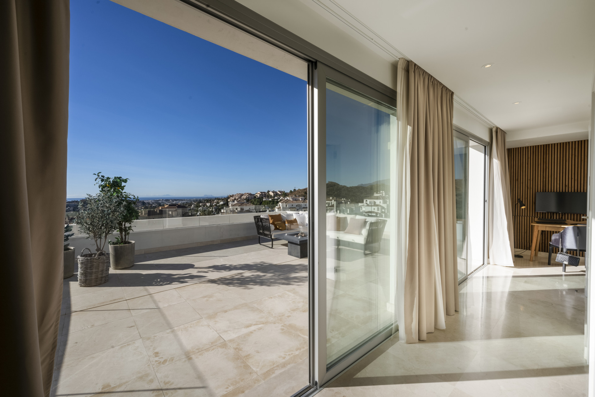Interior view through sliding glass doors leading to the terrace.