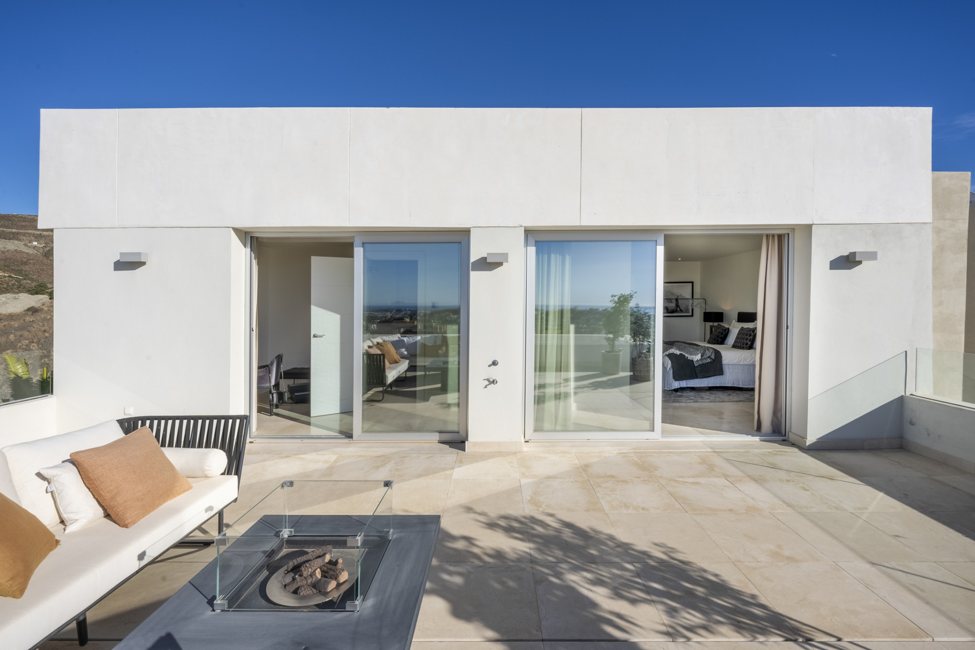 Terrace entrance with glass doors overlooking the view.