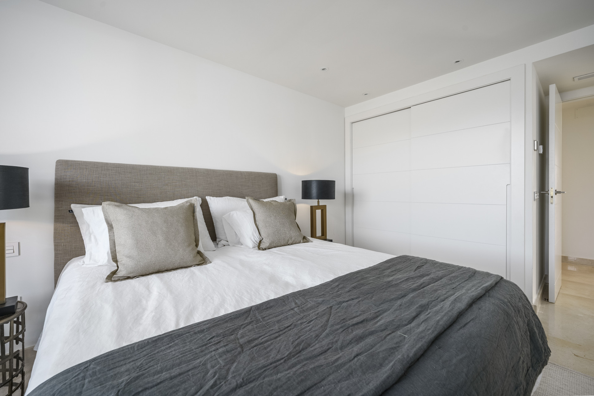 Spacious bedroom featuring a king-size bed and modern storage closet.