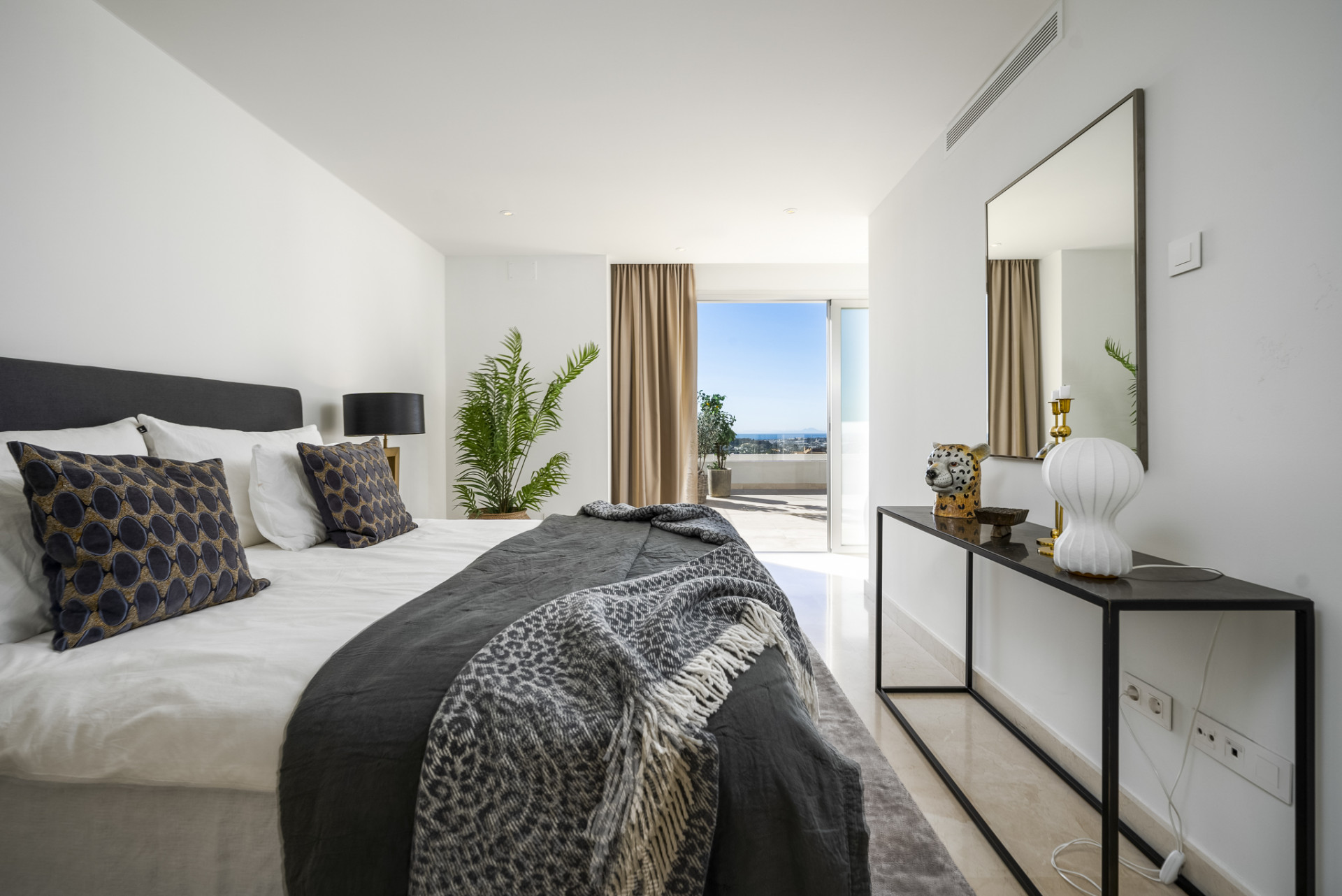 Bright bedroom featuring large windows and stylish decor