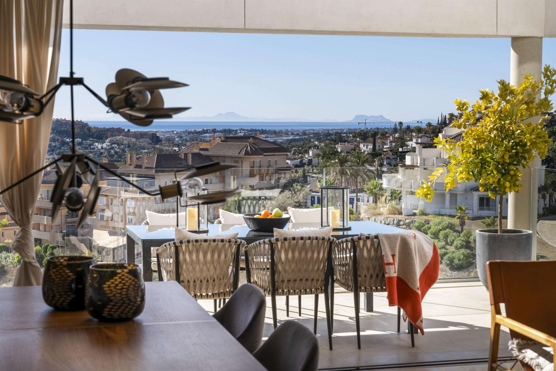 Close-up dining area featuring decorative items, scenic views in the background from large windows.