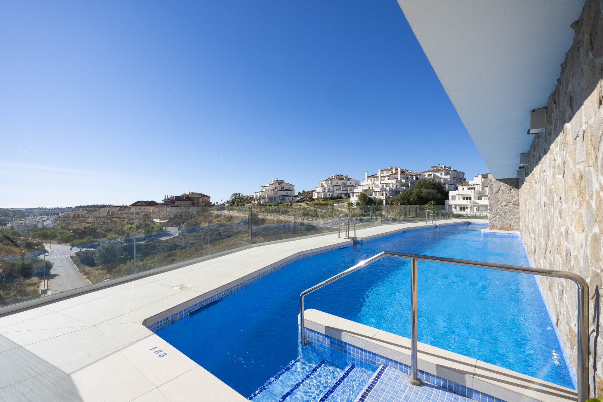 Swimming pool area featuring a modern design and scenic neighborhood view.