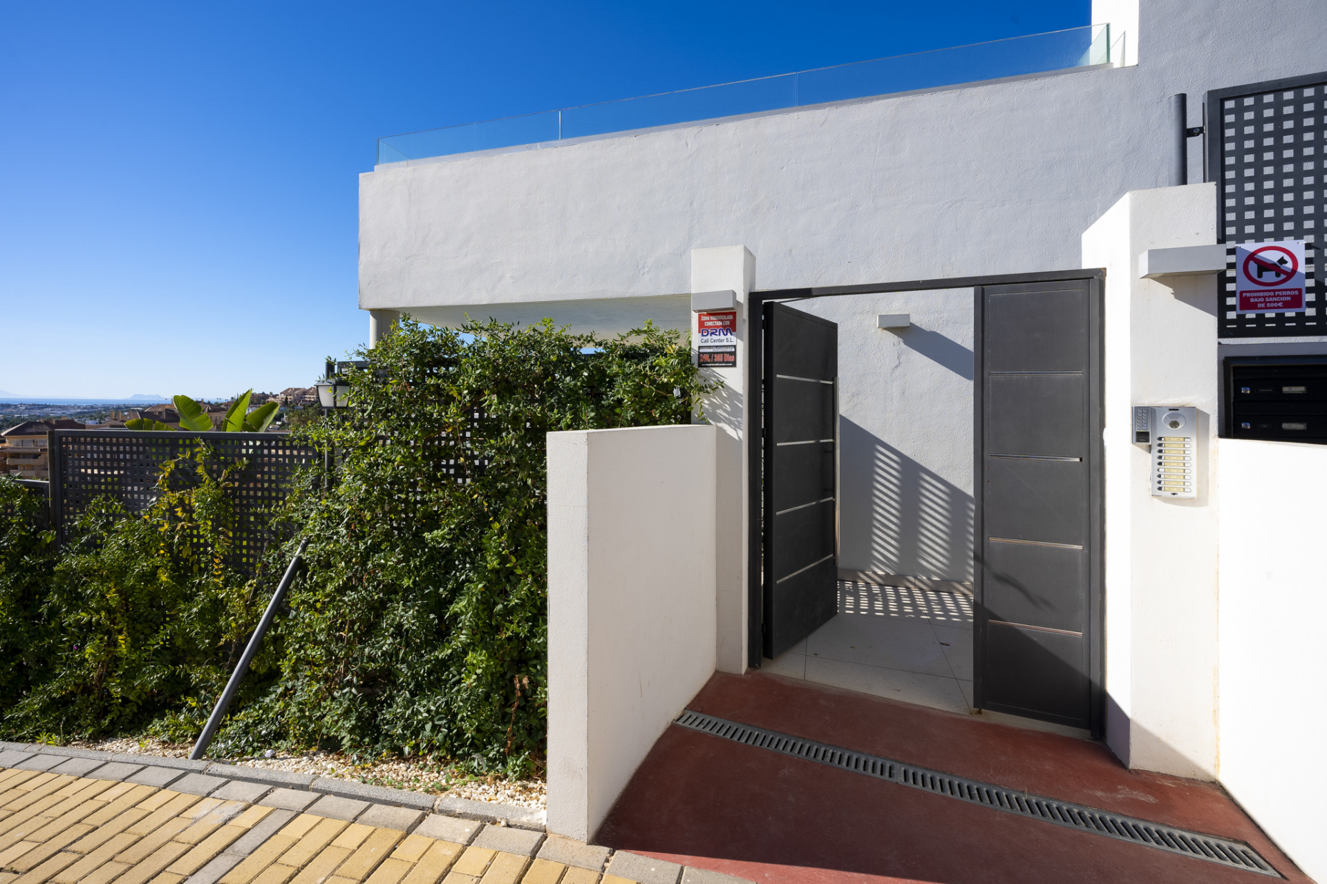 Entrance gate with a view of the pathway leading to the residence.