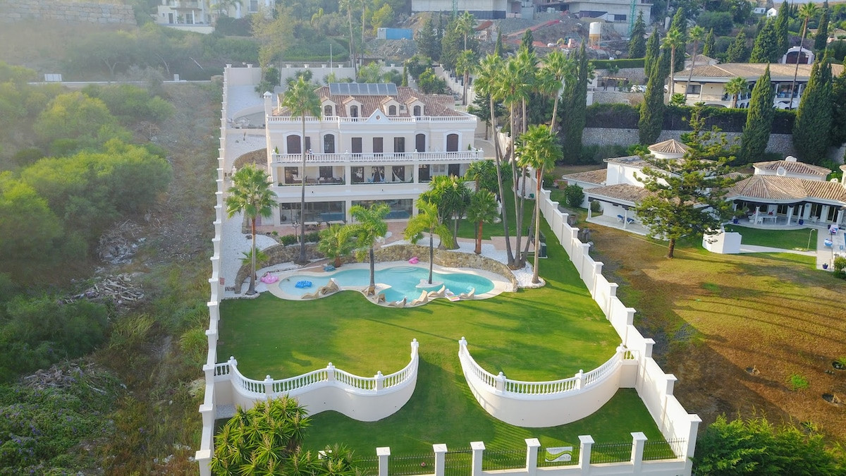Aerial view of the property with a pool and landscaped garden.