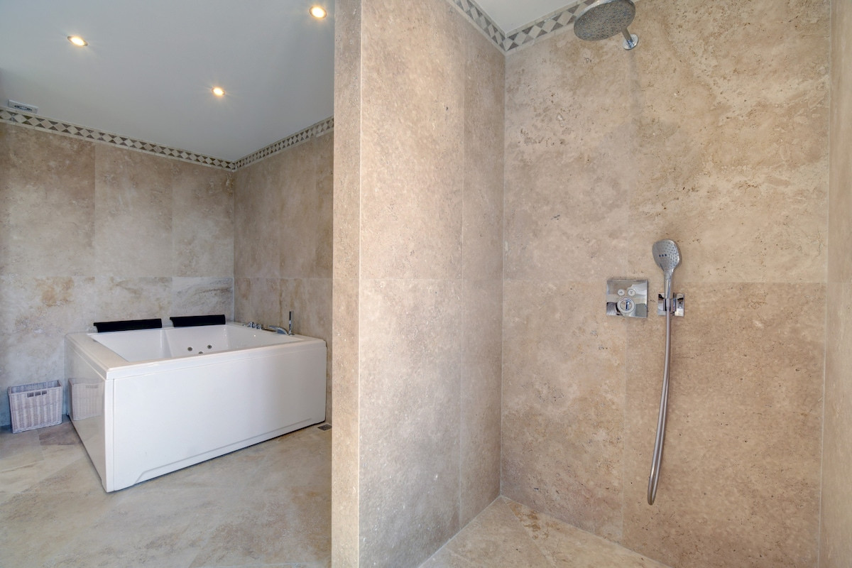 Spa bathroom with a jacuzzi tub and a separate shower area.