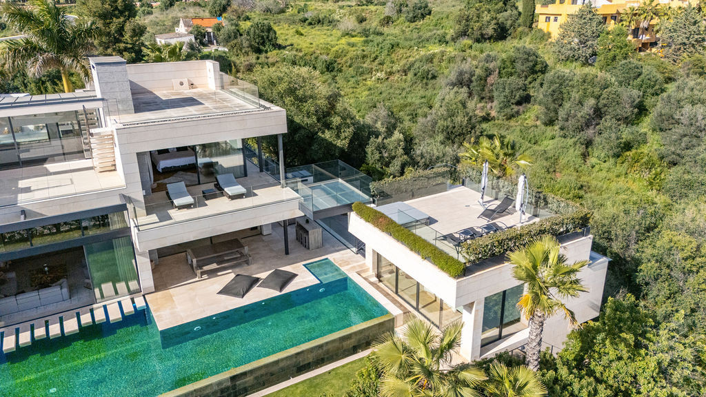 Aerial view of the villa highlighting the pool and surrounding greenery.