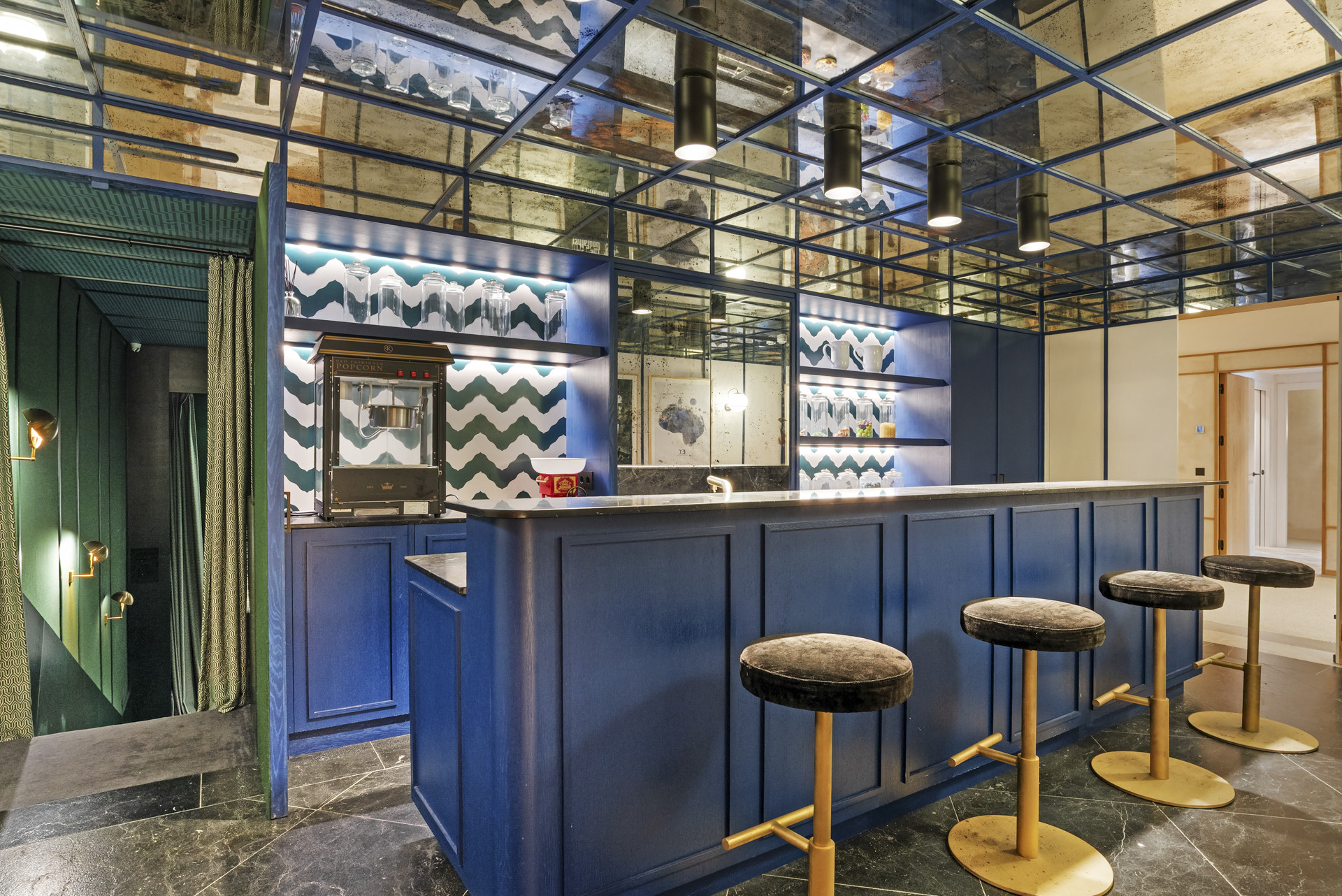 Stylish blue bar area with patterned wall and seating.