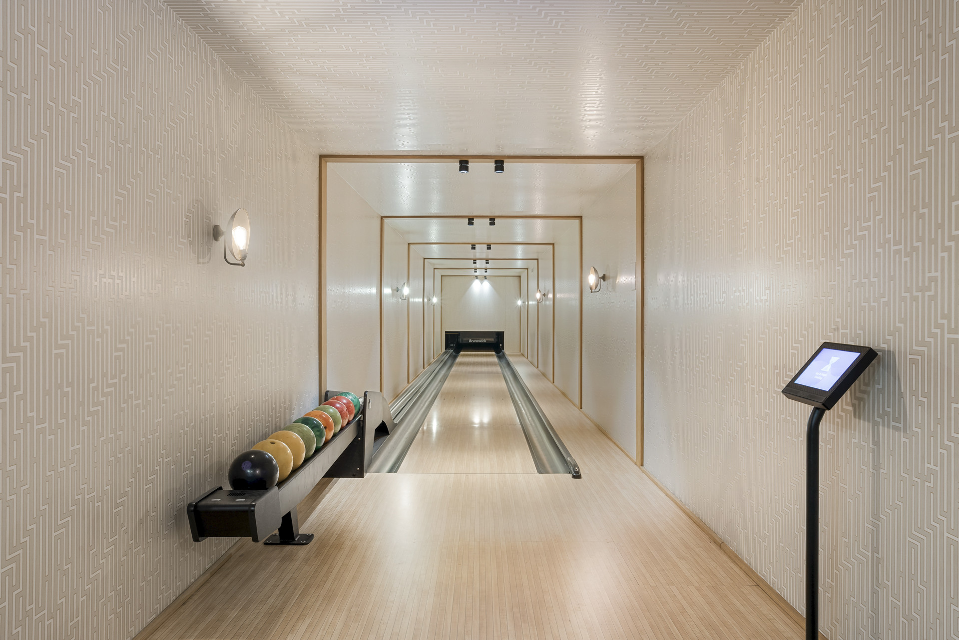 Private bowling alley with colorful balls and modern design.