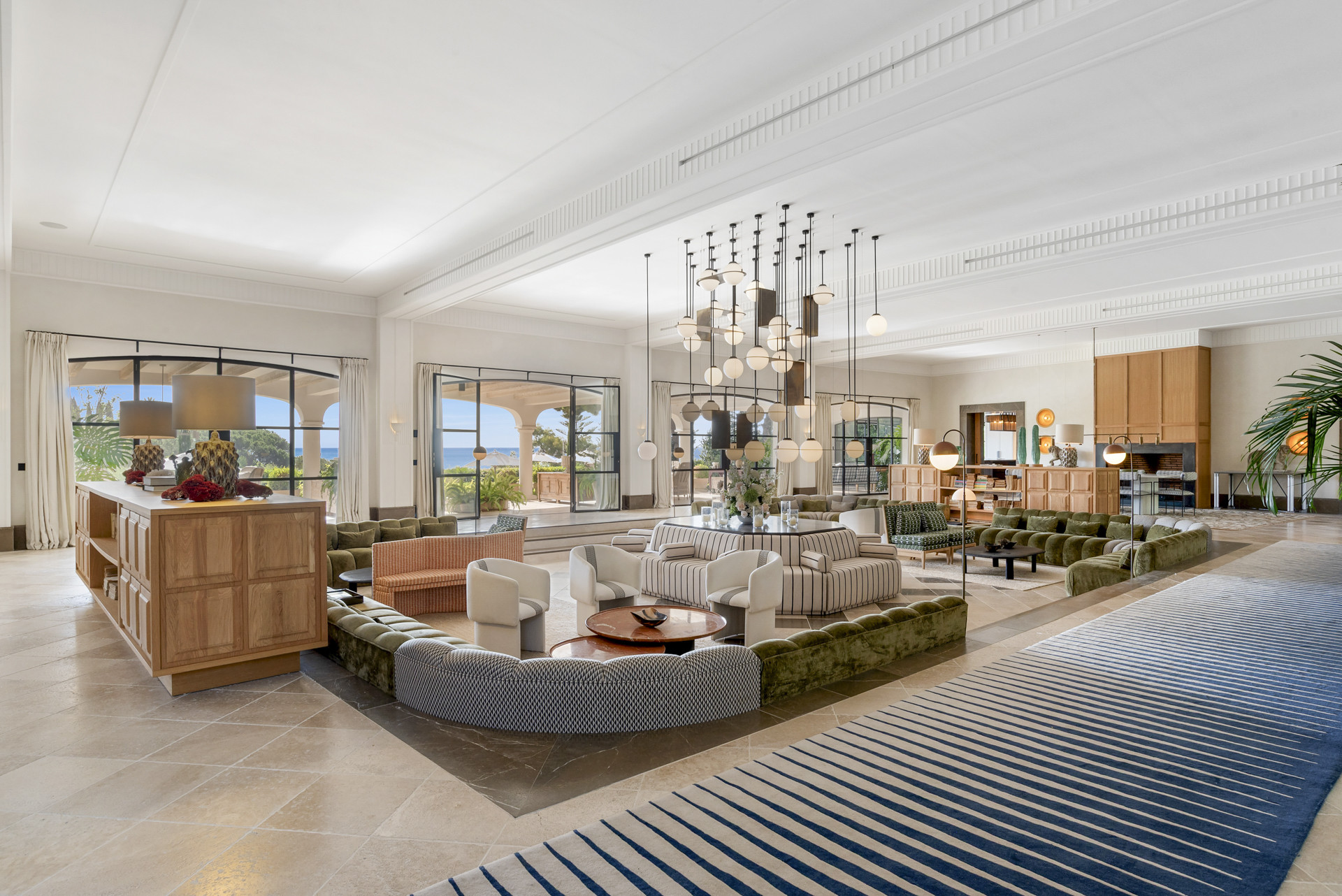 Inviting lounge area with a mix of seating arrangements and open views of an outdoor terrace.