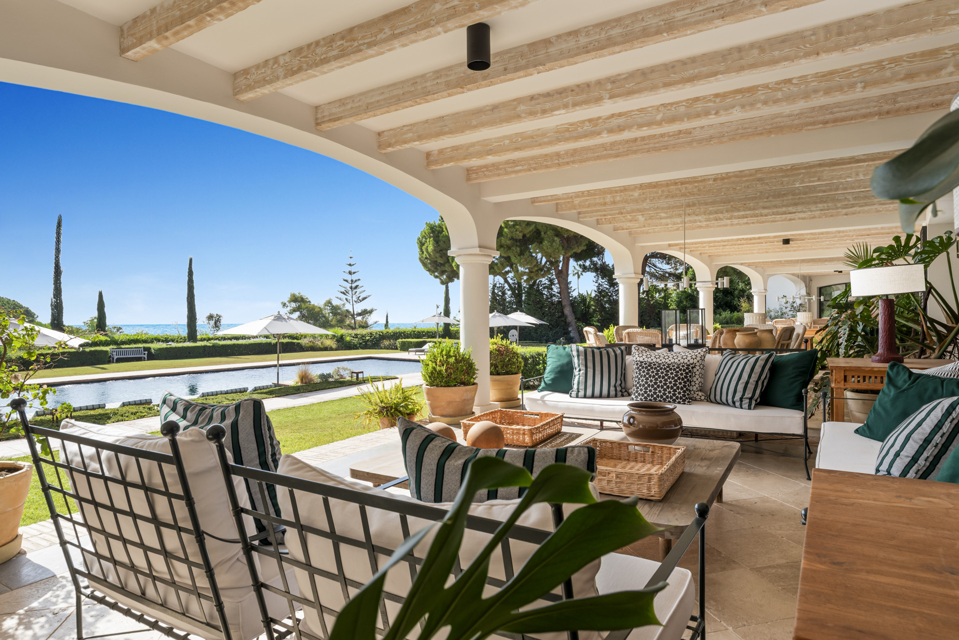 Patio view showing outdoor seating and landscaping surrounding the pool.