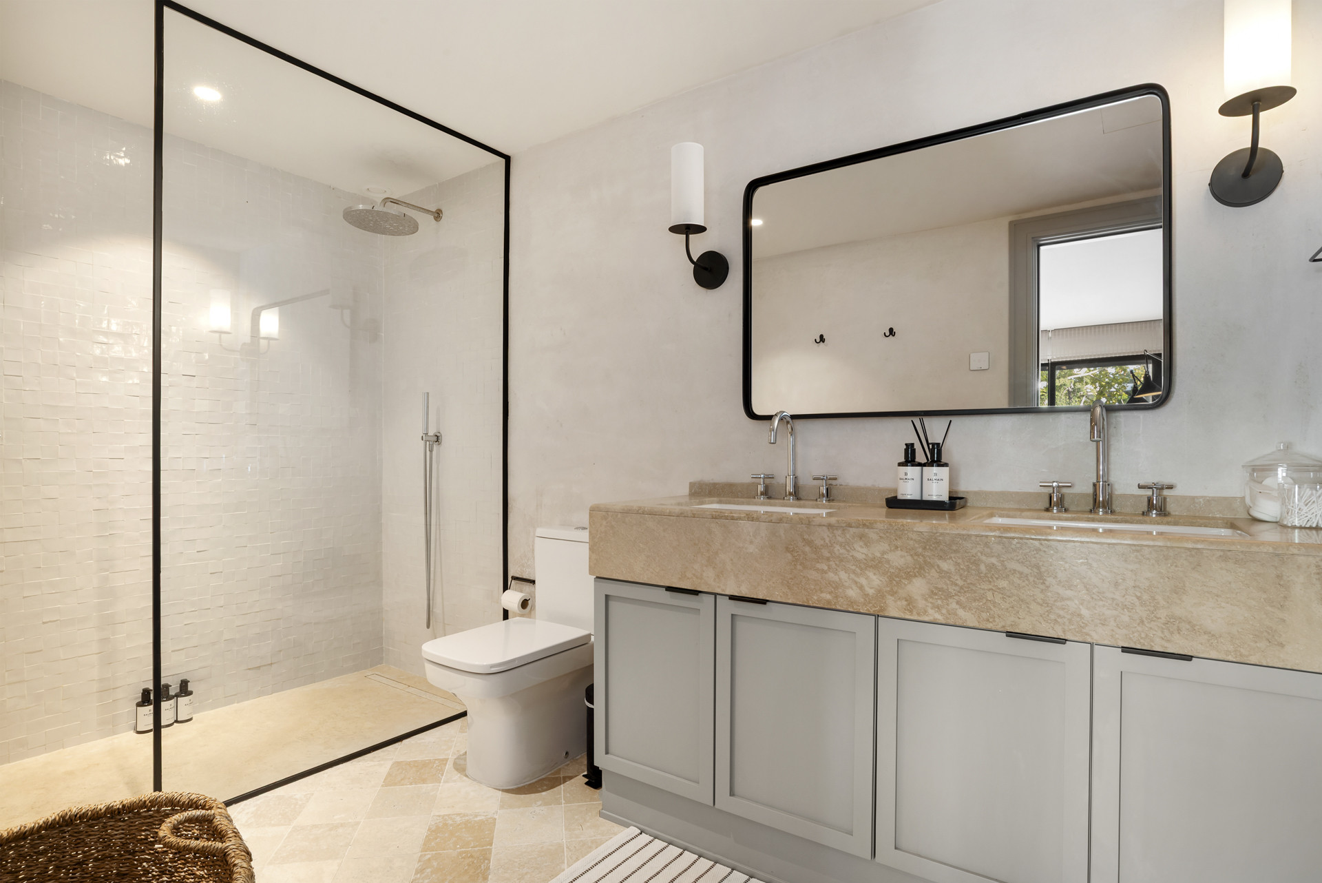 Contemporary bathroom showcasing a dual sink vanity with a large mirror and walk-in shower.