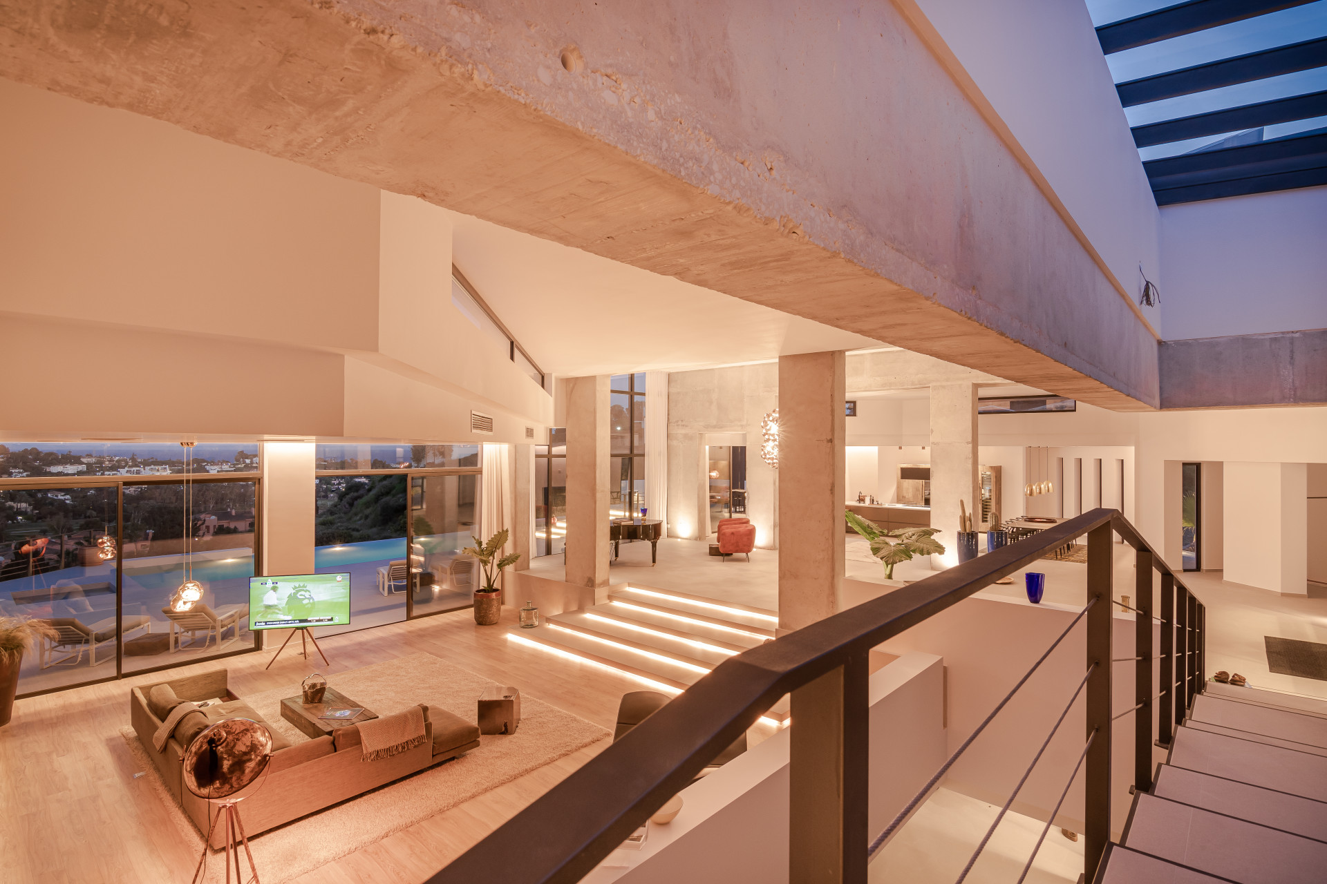 Open living area showcasing modern design and large windows overlooking outdoor space.