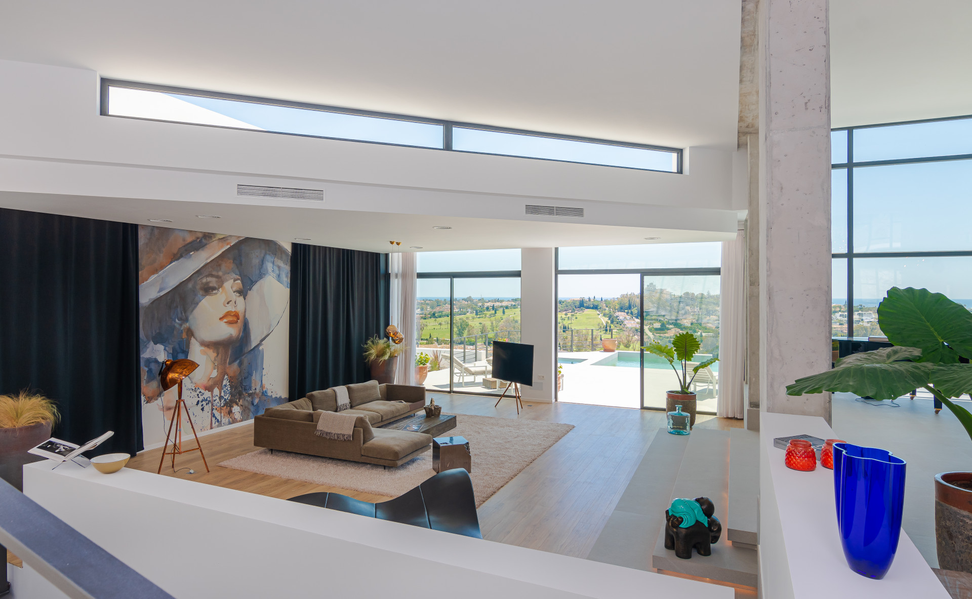 Upper view of the living space showing TV and pool access area.
