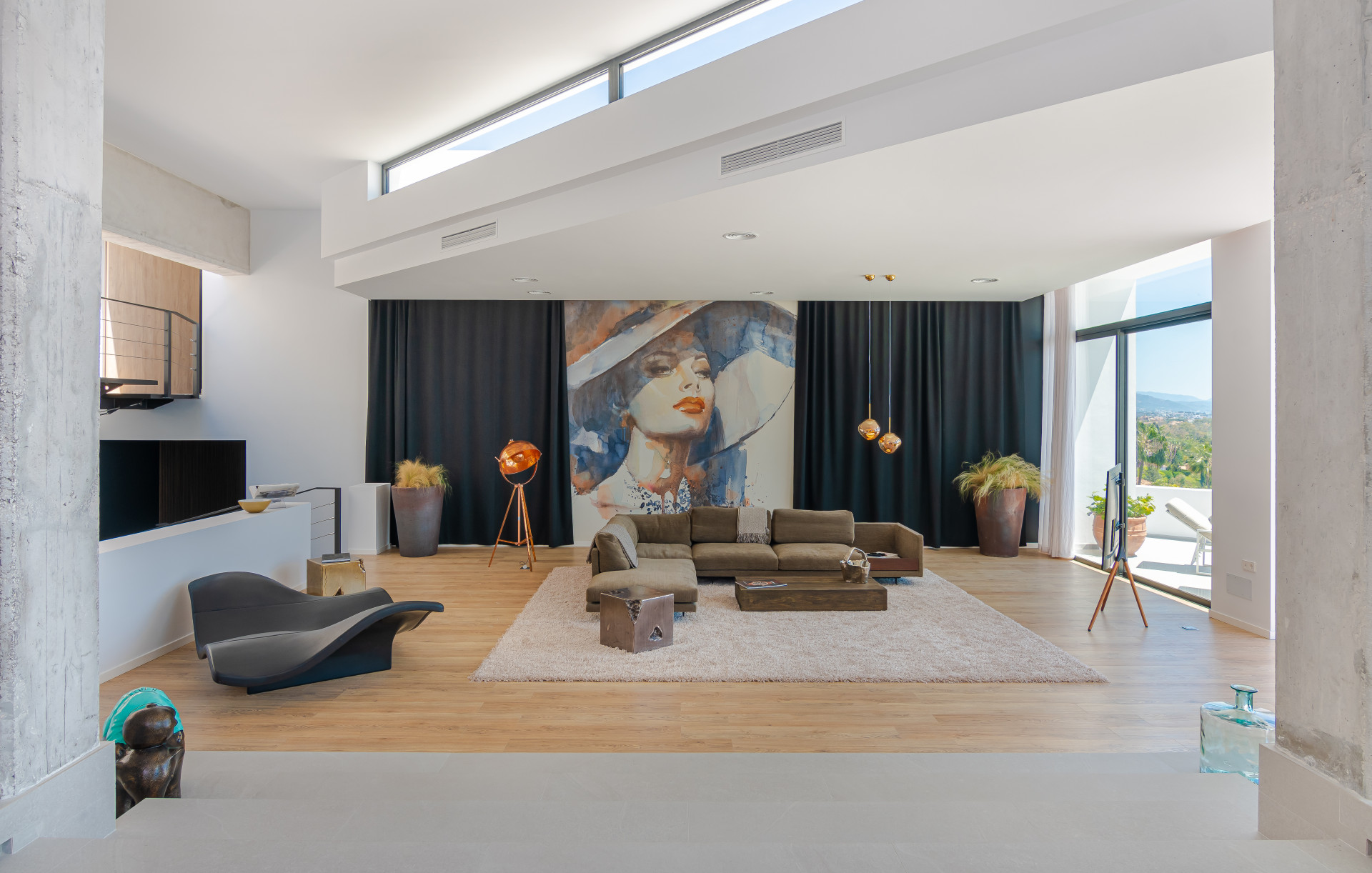 Spacious living room displaying a large painting and seating area.