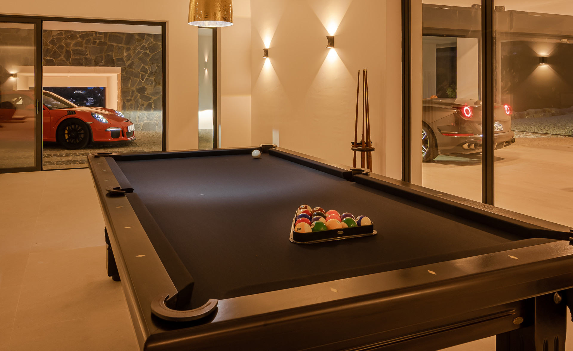 Interior game room with a pool table and glass doors