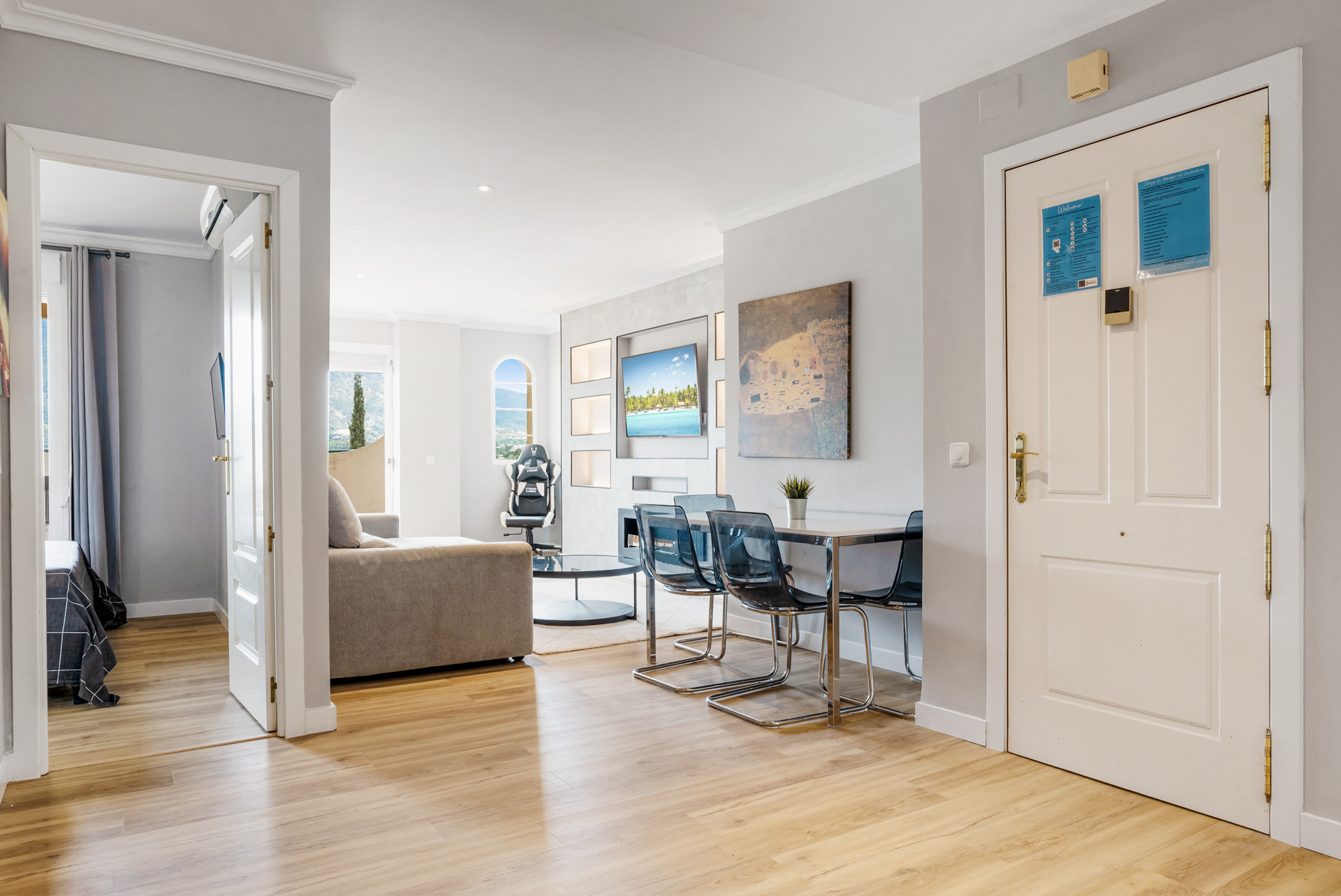 Entrance area with open doors to living space and dining table.