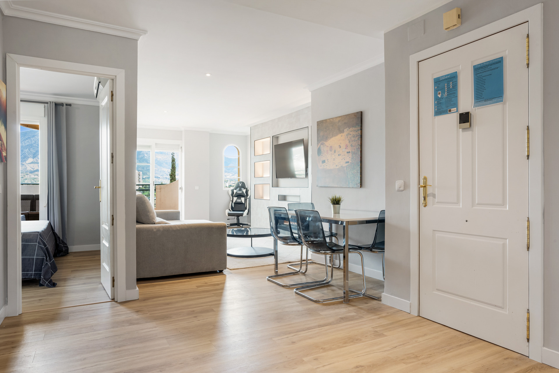 View from the entrance into living area featuring a couch and dining table.