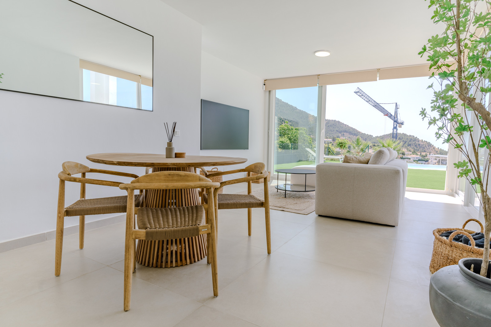 Bright dining space featuring wood accents and a mountain view through large windows.
