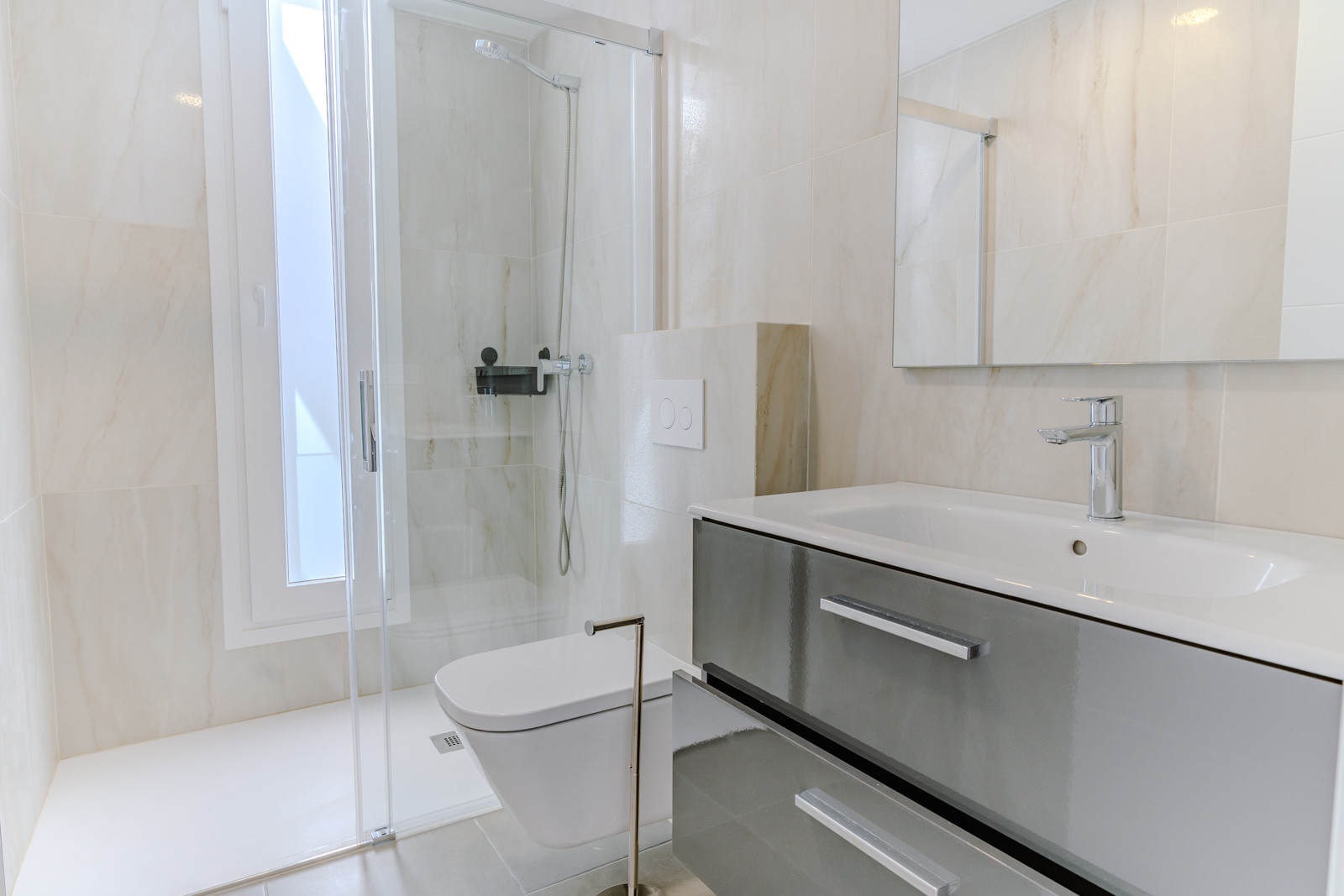 Bathroom featuring a shower, modern vanities, and ample lighting.