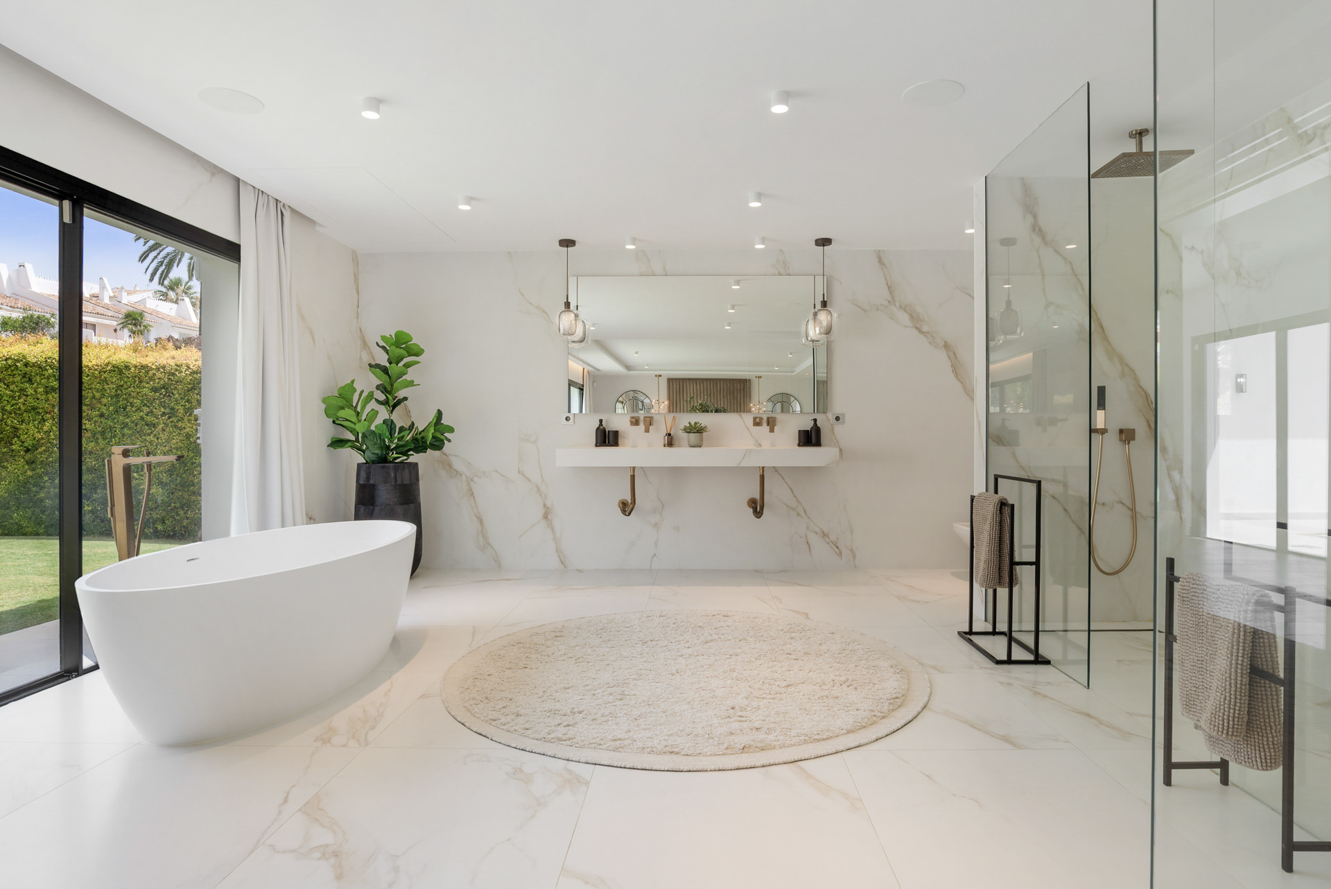 Contemporary bathroom highlights a stylish freestanding tub, double vanity, and natural light from large windows.