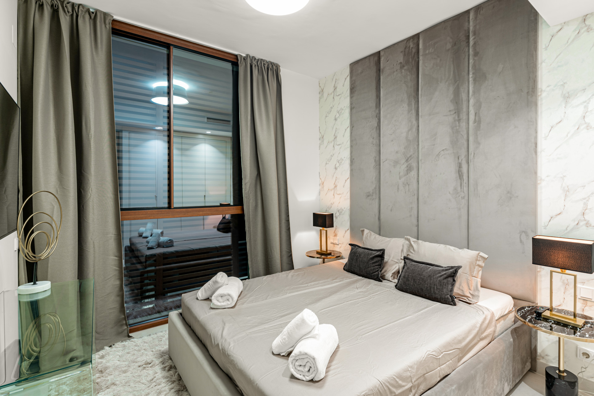 Similar bedroom view featuring decorative elements and nightstands.