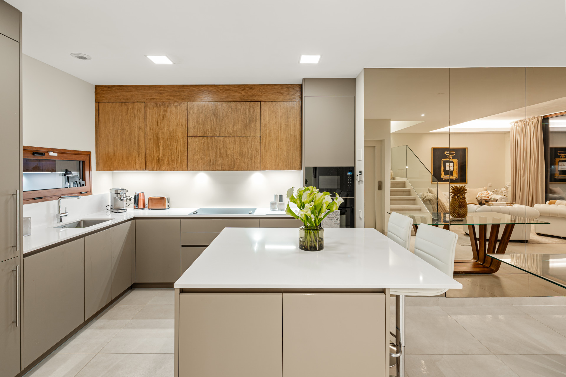 Modern kitchen with wooden cabinets and a central island with flowers.